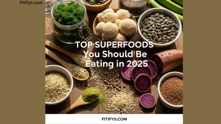 "A flat-lay image showcasing a variety of nutrient-rich superfoods with the text 'Top Superfoods You Should Be Eating in 2025'. Visible foods include spirulina, hemp seeds, quinoa, mushrooms, purple sweet potatoes, lentils, pumpkin seeds, and green beans. The image is branded with 'Fitifys.com' at the bottom."