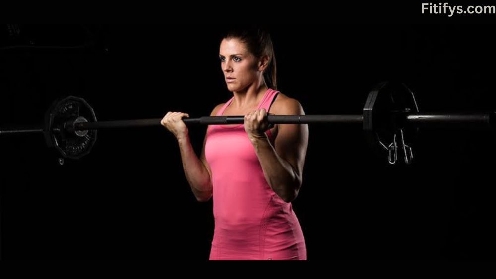 "A woman with focused expression lifting a barbell with weight plates, as seen on Fitifys.com."