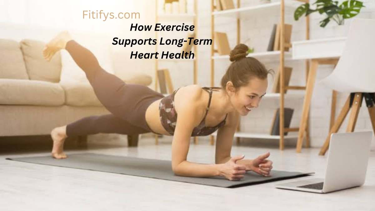 “Smiling woman doing a plank with leg raise while watching a workout video on her laptop at home, promoting long-term heart health through exercise – Fitifys.com branding and motivational headline”