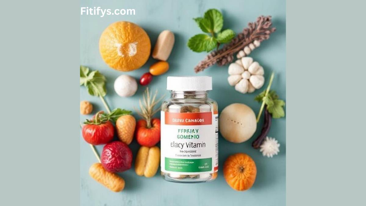 A bottle of dietary supplements labeled “Elacy Vitamin” placed on a flat surface surrounded by fresh fruits and vegetables, including oranges, strawberries, tomatoes, mushrooms, and leafy greens, with the text “Fitifys.com” at the top.