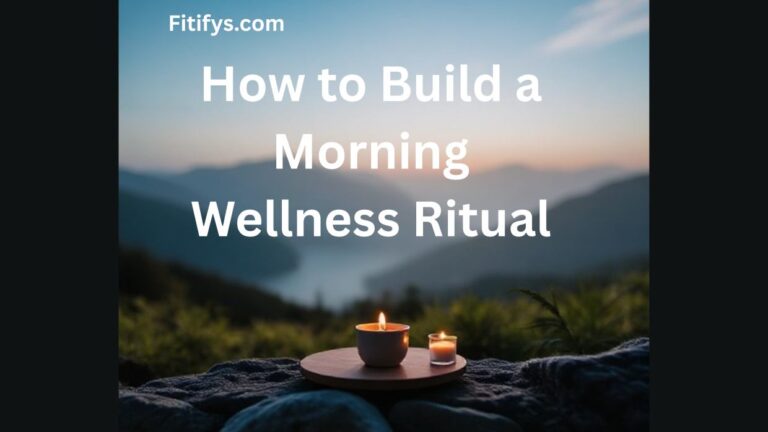 A serene morning scene with a cup and candle placed on a wooden tray outdoors, overlooking misty mountains at sunrise, with the text “How to Build a Morning Wellness Ritual” and “Fitifys.com” at the top.