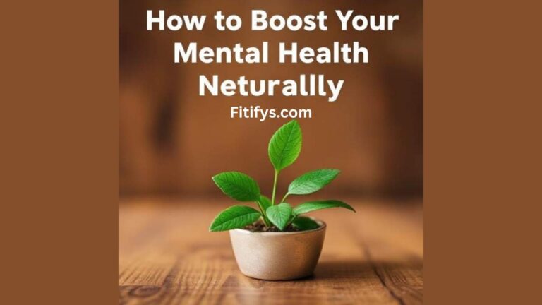 A small green plant with fresh leaves growing in a round beige pot, placed on a wooden surface. Above the plant, large white text reads: "How to Boost Your Mental Health Naturally." The word "Naturally" is misspelled as "Neturallly." The text "Fitifys.com" is written below the main heading. The background is softly blurred with warm brown tones.